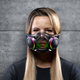 A photo of a woman wearing Razer's new Zephyr air filtration mask, which looks like an RGB cybergoth accessory.